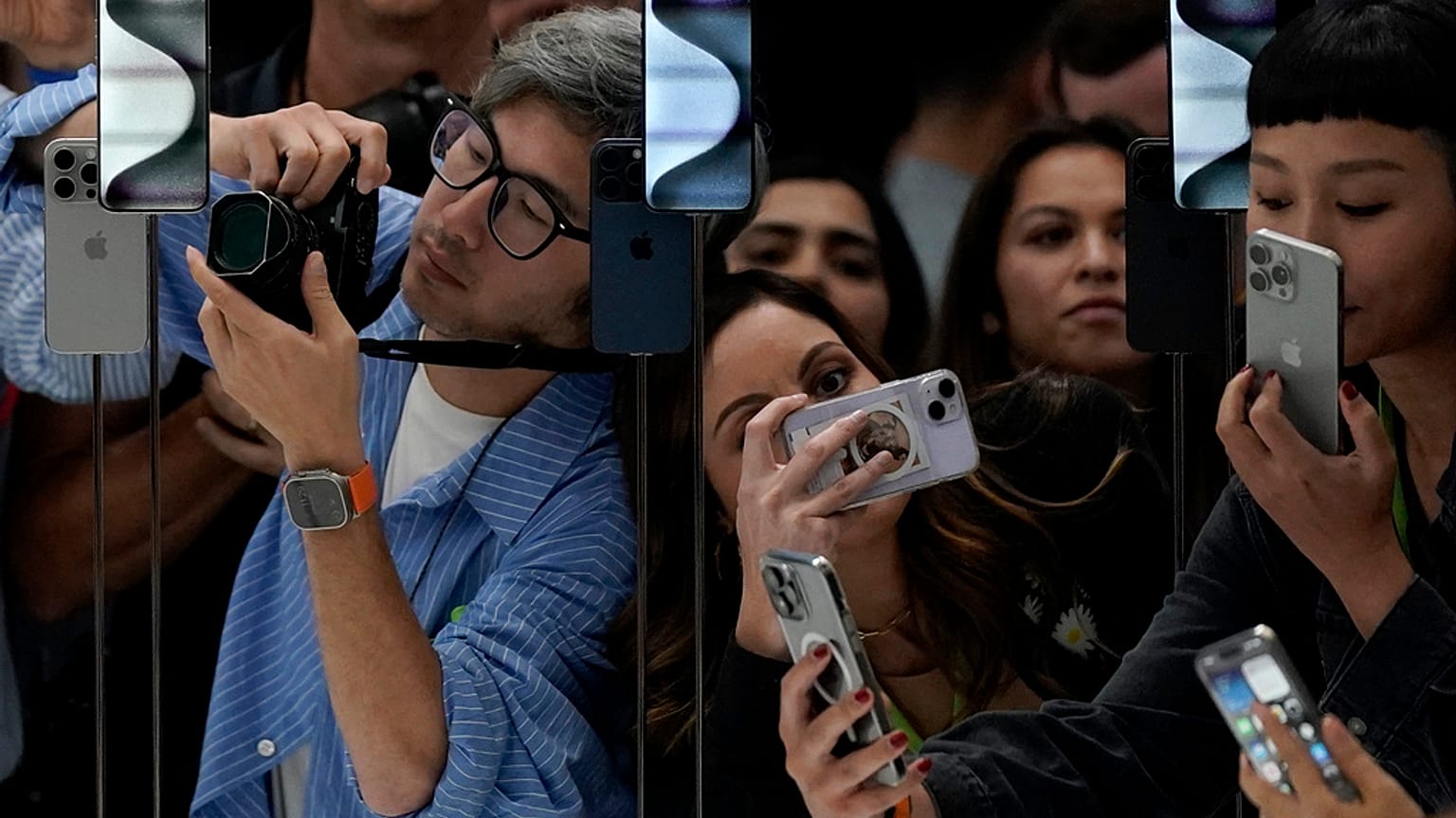 People take photos of the iPhone 15 Pro phones during an announcement of new products on the Apple campus in Cupertino, Calif., Tuesday, Sept. 12, 2023