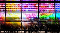 People look at an exhibit of LG Signature OLED T 4K transparent wireless TV's at the LG booth during the CES tech show Tuesday, January 9, 2024, in Las Vegas. 