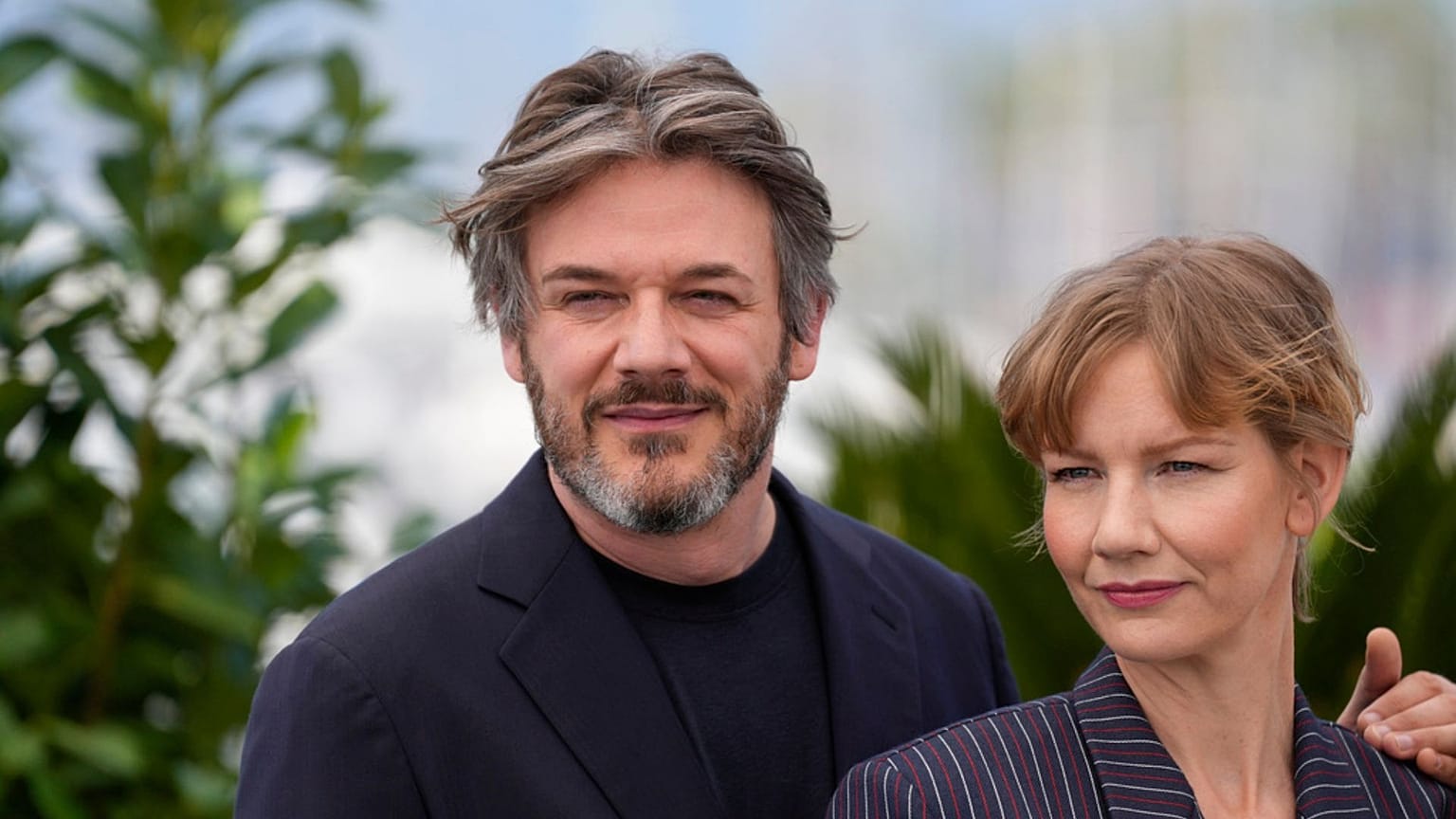 Samuel Theis, left, and Sandra Huller pose for photographers at the photo call for the film 'Anatomy of a Fall' at the 76th Cannes international film festival. 