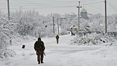 FILE - Ukrainian servicement partrol Verkhnotoretske village in Donetsk region, eastern Ukraine, Monday, Dec. 27, 2021. 