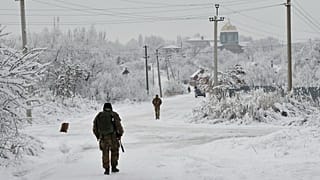 FILE - Ukrainian servicement partrol Verkhnotoretske village in Donetsk region, eastern Ukraine, Monday, Dec. 27, 2021. 
