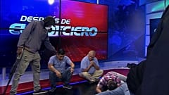 This screen grab of live video from the TC Television network shows a masked, armed person standing over journalists during a live broadcast, in Guayaquil, Ecuador, 9/1/24.