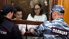 Theater director Zhenya Berkovich and playwright Svetlana Petriychuk stand in a glass cage in a courtroom prior to a hearing in a court in Moscow, Russia, 6 September, 2023.