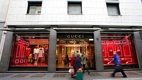 People walk in front of Gucci shop in Monte Napoleone street in Milan, Italy, Thursday, Oct. 20, 2016.