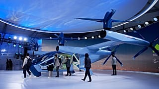 People look at the Supernal S-A2 passenger electric VOTL aircraft at the Supernal booth during the CES tech show Wednesday, January 10, 2024, in Las Vegas.
