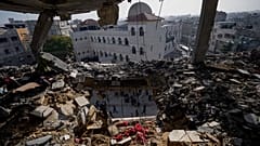 Des Palestiniens observent un immeuble résidentiel endommagé par une frappe israélienne à Rafah, dans le sud de la bande de Gaza.