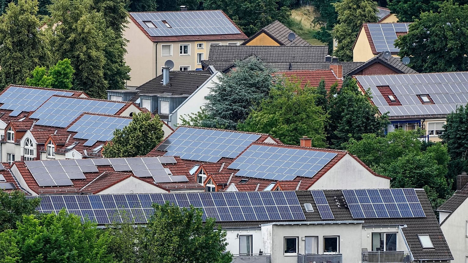 Solar panels are mounted on the roofs of apartment buildings in Bottrop, Germany, June 26, 2023. 