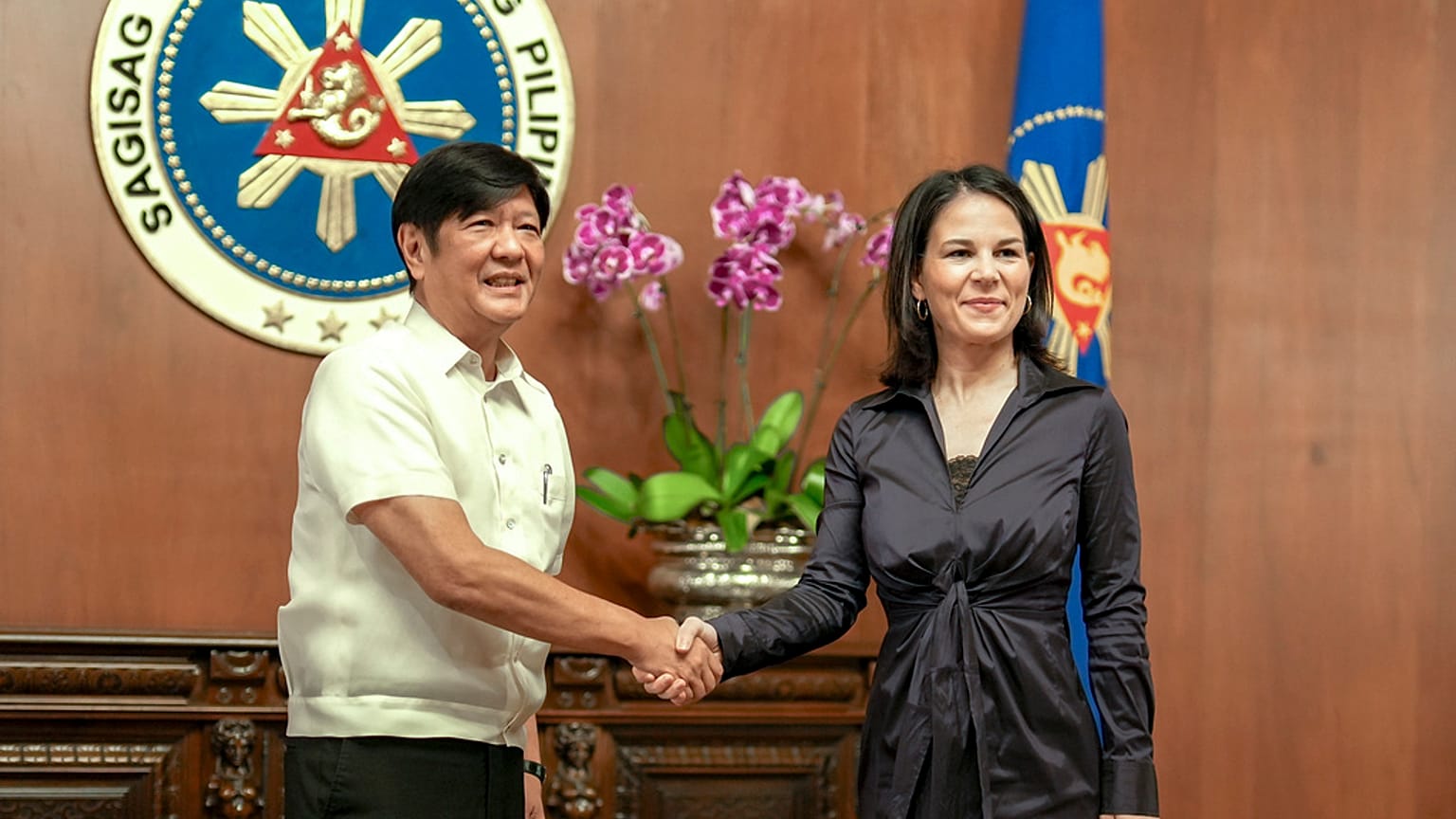 Philippine President Ferdinand Marcos Jr., left, greets German Foreign Minister Annalena Baerbock during her courtesy call at the Malacanang presidential palace in Manila