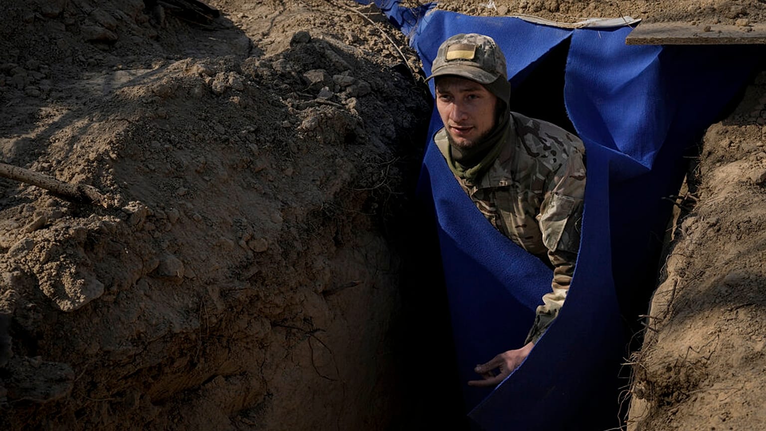 A Ukrainian serviceman exits a bunker on the outskirts of Kyiv, Ukraine, Sunday, March 20, 2022