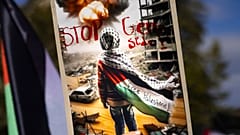 Protesters hold Palestinian flags and placards reading "Free Palestine" and "Stop genocide" during a rally supporting the Palestinian people, in Zurich, Switzerland, Saturday,
