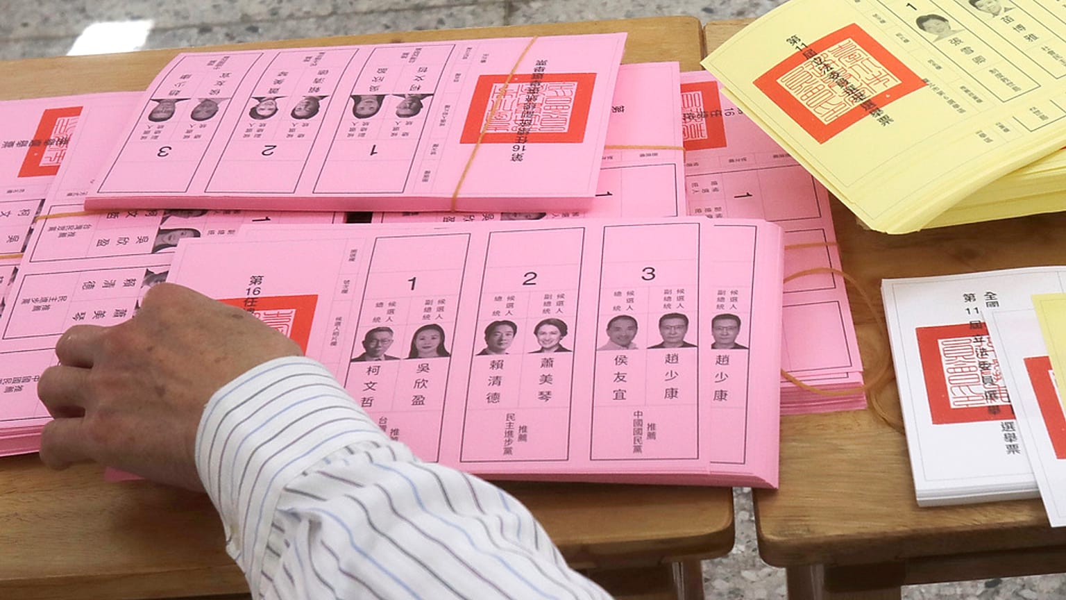 A staff sorts ballot papers at a polling station in Taipei, Taiwan on Saturday