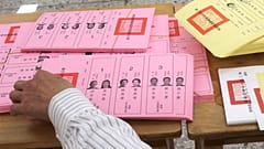 A staff sorts ballot papers at a polling station in Taipei, Taiwan on Saturday
