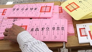 A staff sorts ballot papers at a polling station in Taipei, Taiwan on Saturday