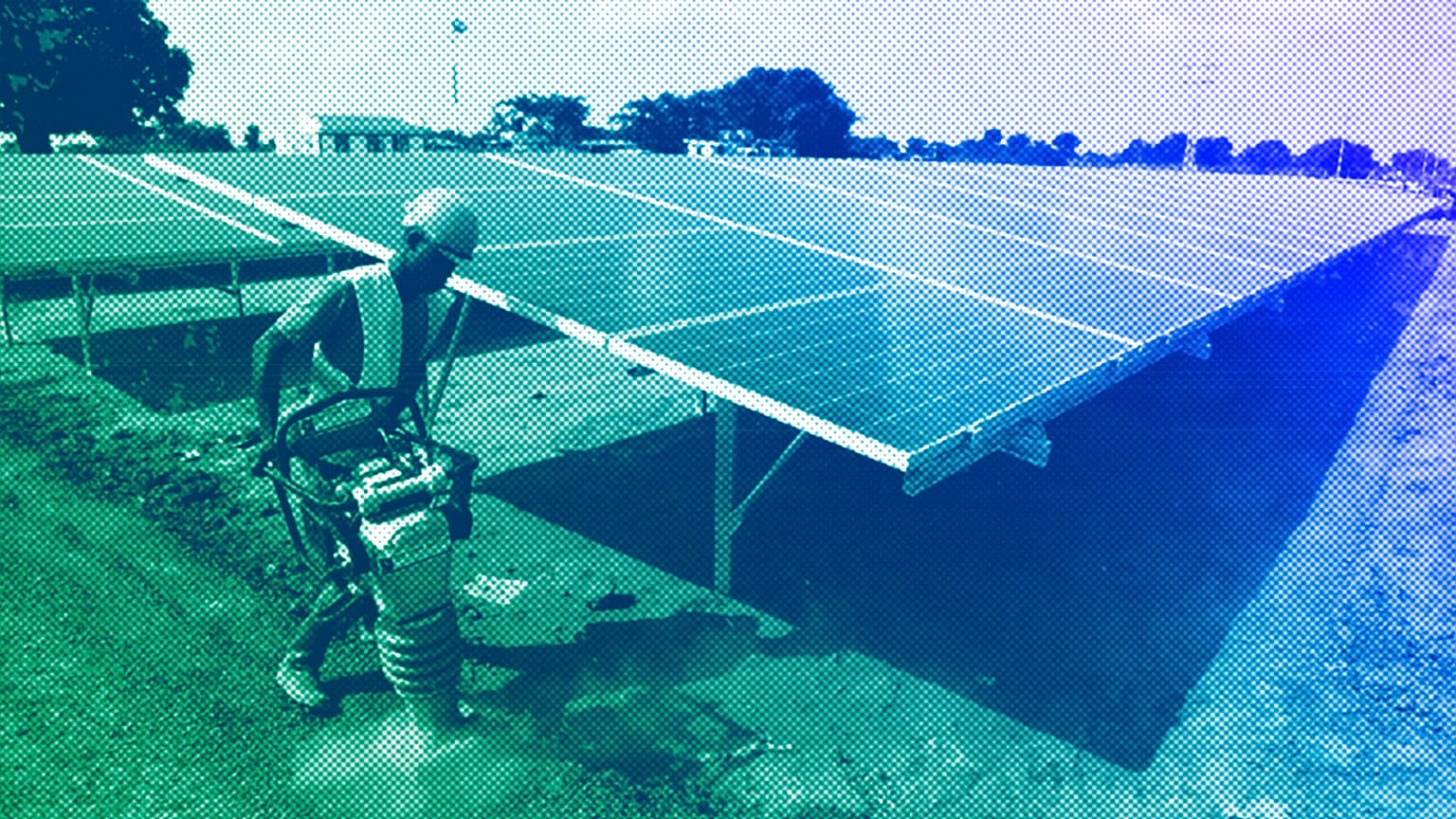 Worker levels the ground at a solar plant in Soroti about 300 kilometers east of Uganda capital Kampala, June 2016