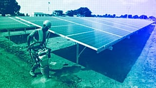Worker levels the ground at a solar plant in Soroti about 300 kilometers east of Uganda capital Kampala, June 2016