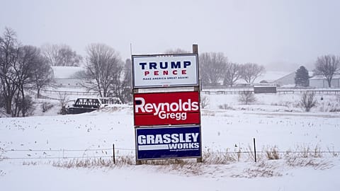 Campaign signs are seen during a winter storm in Sioux City, Iowa