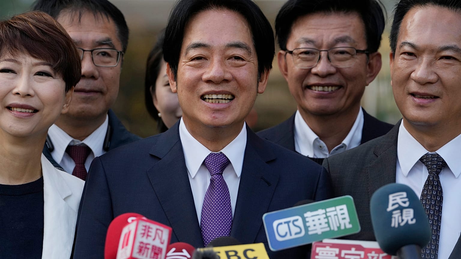 Democratic Progressive Party presidential candidate Lai Ching-te, center, who also goes by William, speaks to the media