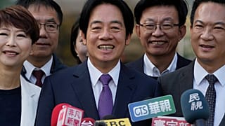 Democratic Progressive Party presidential candidate Lai Ching-te, center, who also goes by William, speaks to the media
