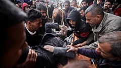 Palestinians evacuate a wounded man after an Israeli strike in Kahan Younis, Gaza Strip