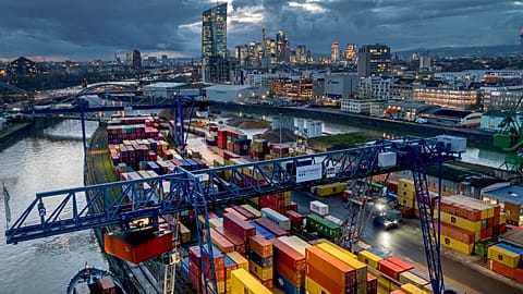 A container is loaded onto a cargo ship in the harbor in Frankfurt, Germany, Wednesday, Dec. 13, 2023. 