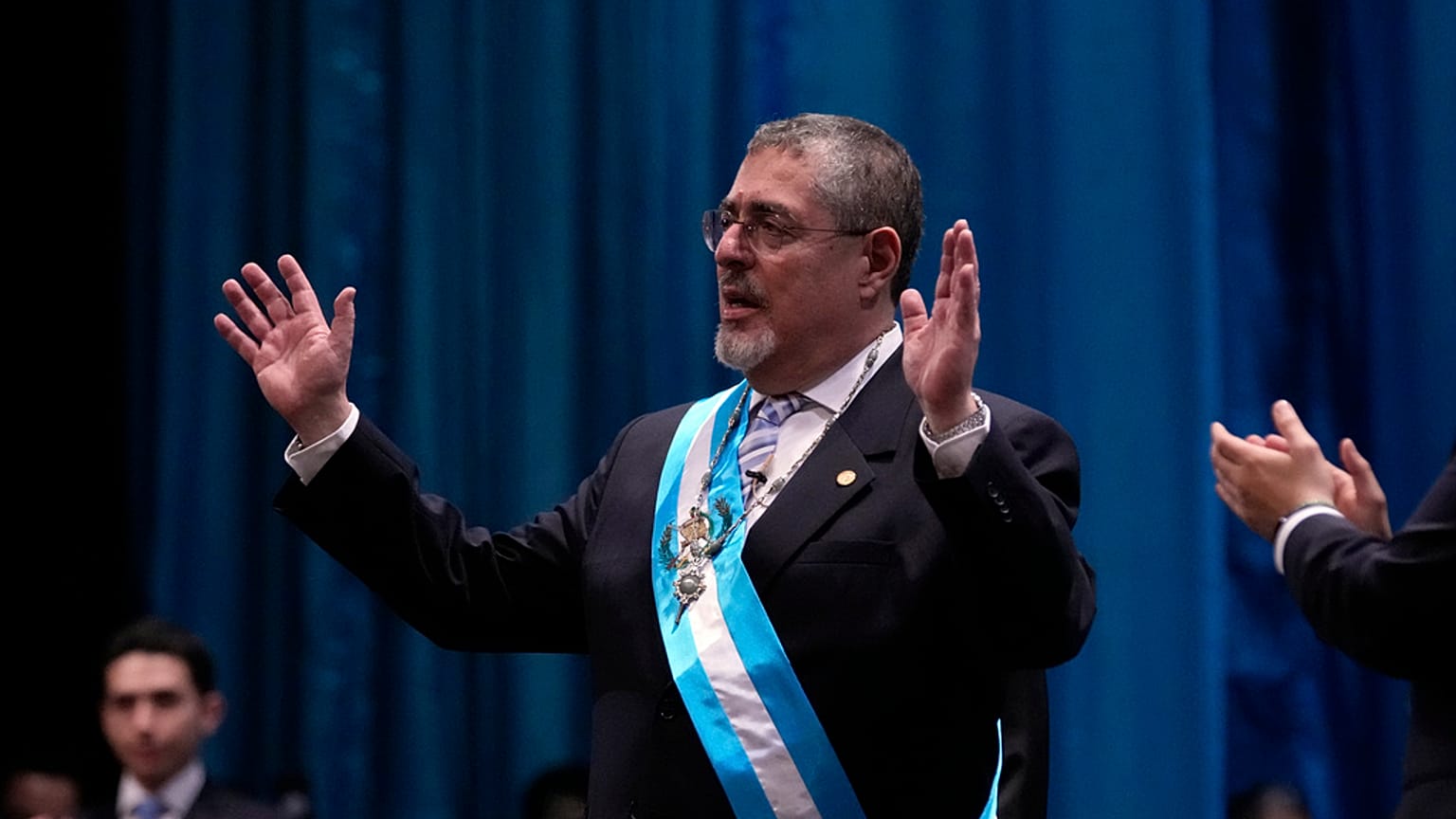 Incoming Guatemalan President Bernardo Arévalo acknowledges the crowd after receiving the presidential sash during his swearing-in ceremony in Guatemala City.