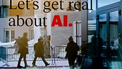 People reflected in a window of a hotel at the Davos Promenade with a slogan about AI alongside the World Economic Forum in Davos, Switzerland, Monday, January 15, 2024.