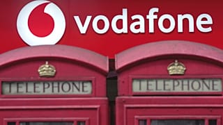 Phone boxes are placed in front of a Vodafone store in London, Wednesday, June 14, 2023.