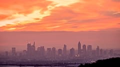 The sky reddens as the sun rises over the buildings of the banking district in Frankfurt, Germany, on Tuesday Jan. 16, 2024