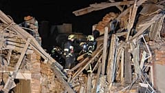 In this photo provided by Kharkiv Regional Administration, emergency workers work in an apartment house damaged in Russian rocket attack is seen in Kharkiv, Ukraine, in the ea