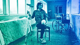Ruslana Danylkina, 19, a Ukrainian soldier who lost her leg in the fighting near Kherson, holds her crutches in a city hospital in Odesa, February 2023