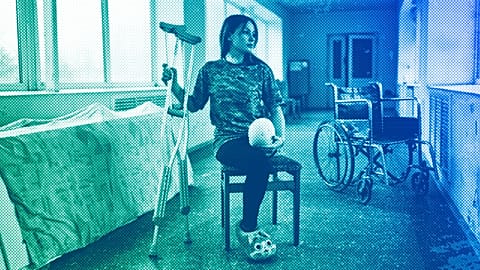 Ruslana Danylkina, 19, a Ukrainian soldier who lost her leg in the fighting near Kherson, holds her crutches in a city hospital in Odesa, February 2023