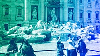 Tourists throw their coins into the Trevi fountain as a wish to come back to the eternal city, in downtown Rome, June 2021