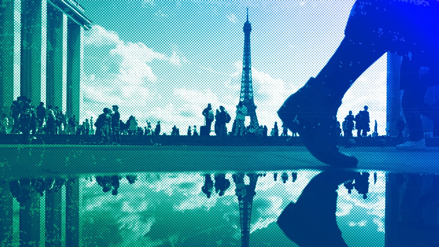 The Eiffel Tower is reflected in a puddle as people walk past at the Trocadero square, in Paris, October 2023