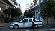 FILE: Police officers block a street in Athens, 13 November 2018