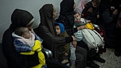 Palestinians line up with their children to receive vaccination against diseases, which recently entered Gaza as part of aid, in Rafah, southern Gaza Strip.