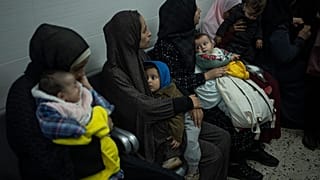 Palestinians line up with their children to receive vaccination against diseases, which recently entered Gaza as part of aid, in Rafah, southern Gaza Strip.