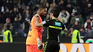 Referee Enzo Maresca, right, speaks to AC Milan's Mike Maignan during the Italian Serie A soccer match between Udinese and AC Milan, 20 Jan 2024
