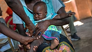 A baby from the Malawi village of Tomali is injected with the world's first vaccine against malaria in a pilot programme, in December 2019.