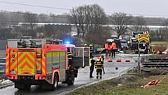 Policemen and railway inspectorate staff work at the scene of a train crash where a fast train collided with a truck at a level crossing in Dolni Lutyne, Czech Republic