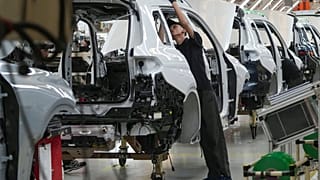 An employee works on a car on the assembly line at the BMW Production Network 2 at Gaya Motor plant in Jakarta, Indonesia, Tuesday, June 6, 2023. (AP Photo/Tatan Syuflana)