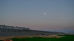 The moon rises over the Pournara migrant reception center in Kokkinotrimithia outside of capital Nicosia, Cyprus on Wednesday