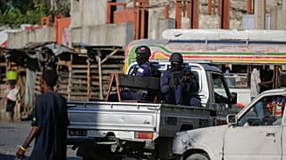Police patrol through the streets of downtown Port-au-Prince, Haiti.
