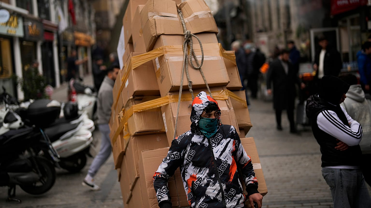 A man pulls a trolley with goods in Eminonu commercial area in Istanbul, Turkey, Thursday, Jan. 25, 2024.  