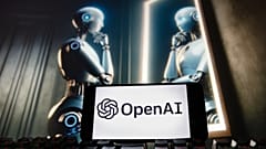 The OpenAI logo is seen displayed on a cell phone with an image on a computer monitor generated by ChatGPT's Dall-E text-to-image model, Friday, Dec. 8, 2023, in Boston. 