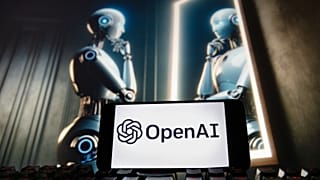 The OpenAI logo is seen displayed on a cell phone with an image on a computer monitor generated by ChatGPT's Dall-E text-to-image model, Friday, Dec. 8, 2023, in Boston. 