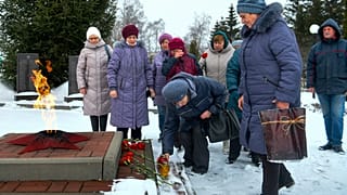 Women lay flowers in memory of those who were killed in the plane on Wednesday in Yablonovo, Belgorod region, Russia