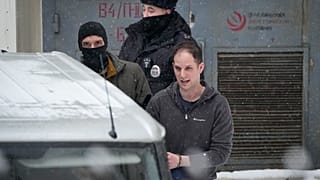  Wall Street Journal reporter Evan Gershkovich, right, is escorted from the Lefortovsky court in Moscow, Russia on Friday