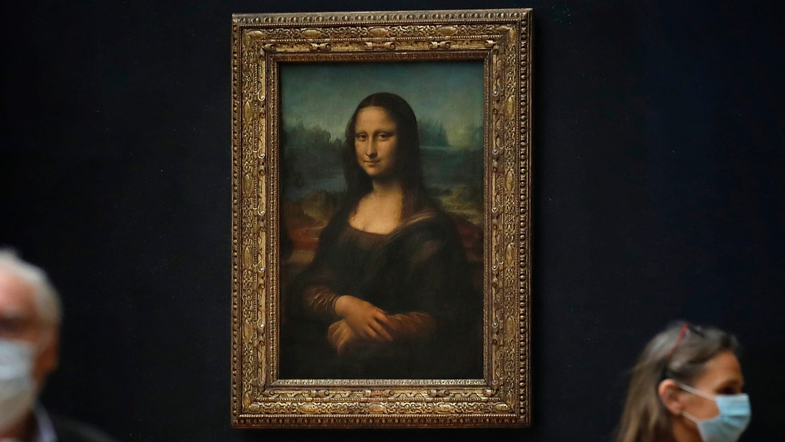 FILE - Journalists walk past Leonardo da Vinci's Mona Lisa during a visit of the Louvre museum Tuesday, June 23, 2020.