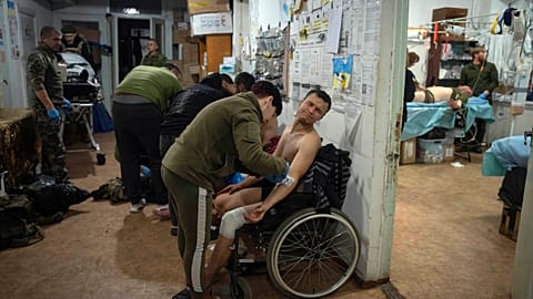 Military medics give first aid to wounded Ukrainian soldiers at a medical stabilization point near Bakhmut, Donetsk region in Ukraine