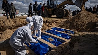 Palestinians bury the bodies of people who were killed in fighting with Israel and returned to Gaza by the Israeli military, during a mass funeral in Rafah, Gaza on Tuesday